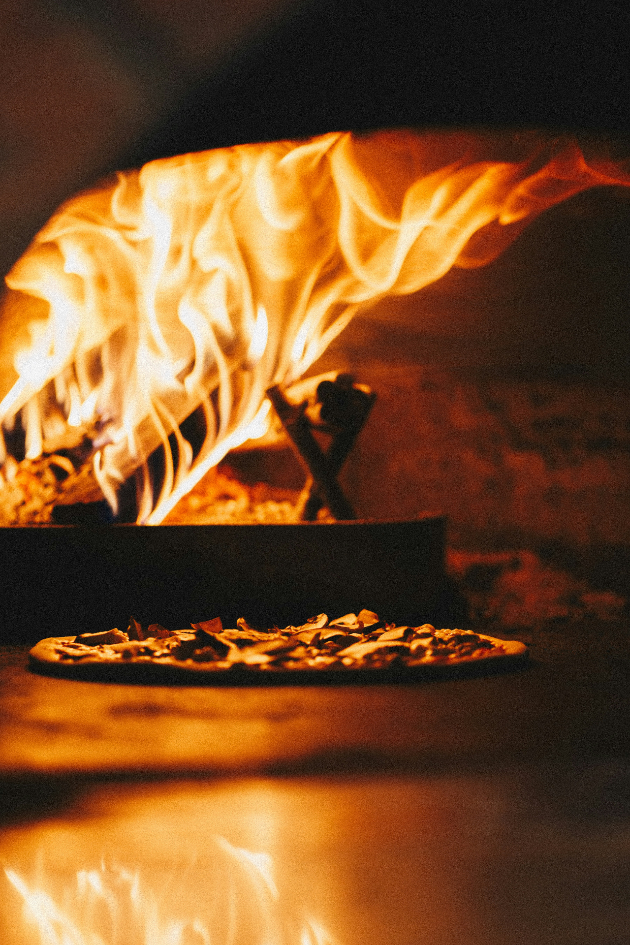 Pizza in front of roaring wood fire