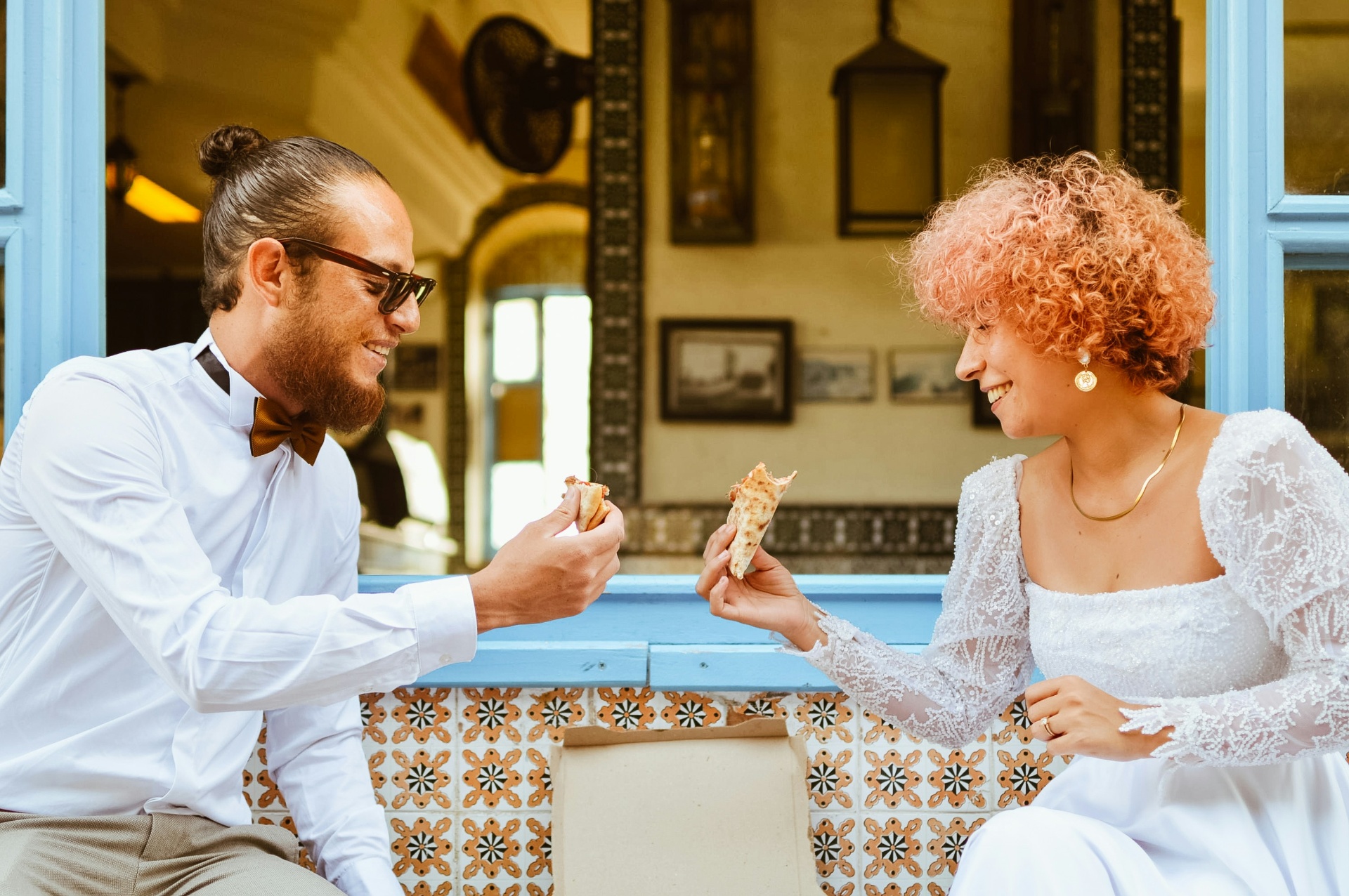 Bride and groom sharing pizza